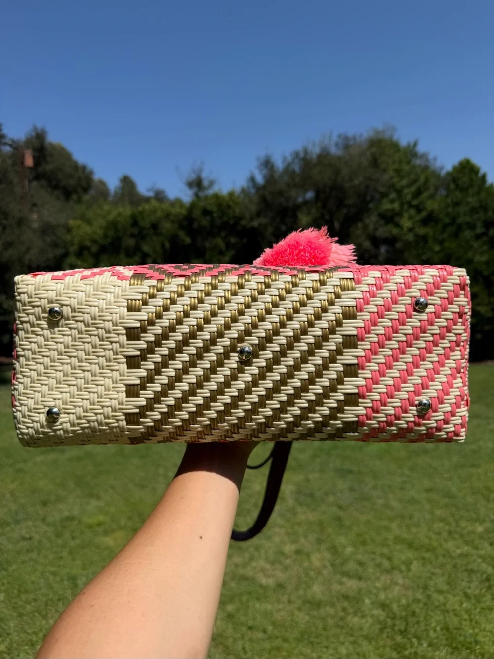 Woven Straw Tote Bag with Brown Leather Handles and Pink Tassel Accent